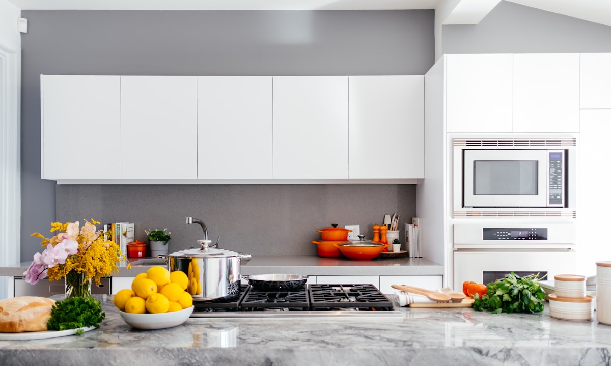 Bright home kitchen counter with fresh ingredients and cookware ready for prep